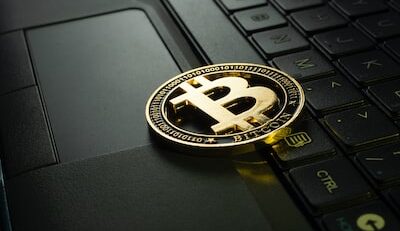 An image showcasing a bustling Hong Kong skyline at night, with brightly lit online gambling platforms integrated seamlessly among traditional establishments, symbolizing the rise of cryptocurrencies as a popular payment option in the city's gambling industry